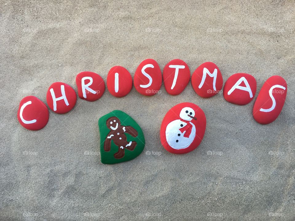 Christmas symbols on painted stones 