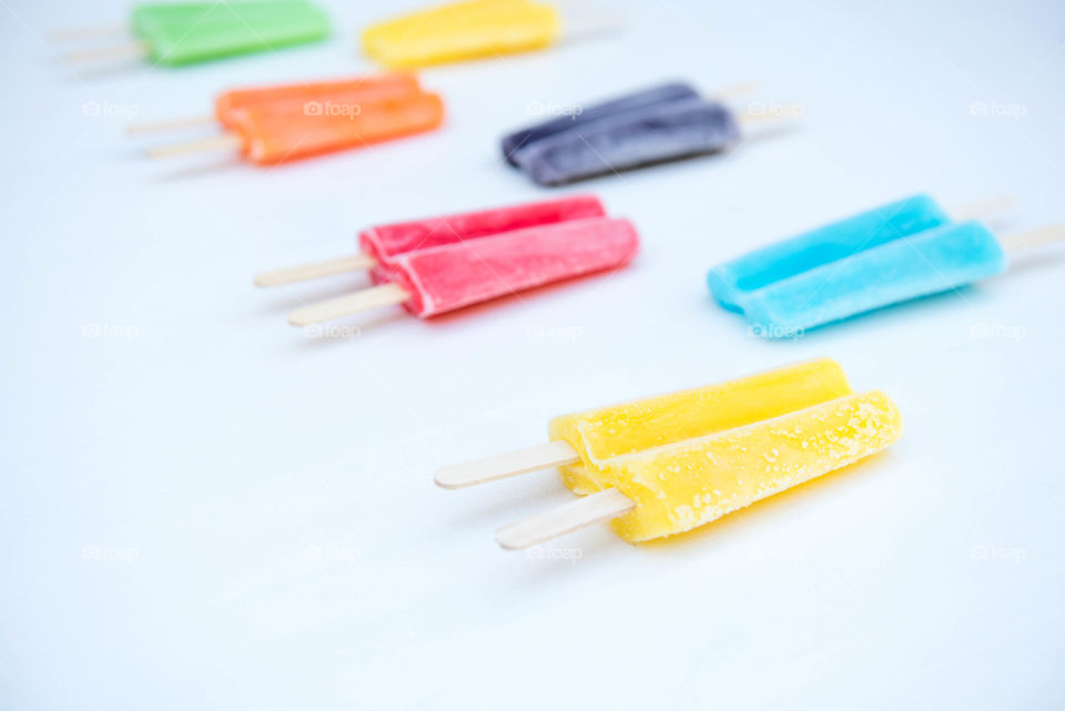 Rows of brightly colored frozen popsicles 