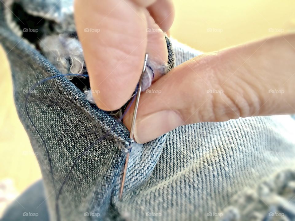 Person stiching denim