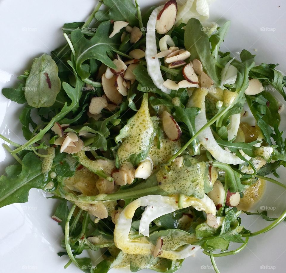 Greens at Lunch. Arugula Salad With Vinaigrette and Almond Garnish