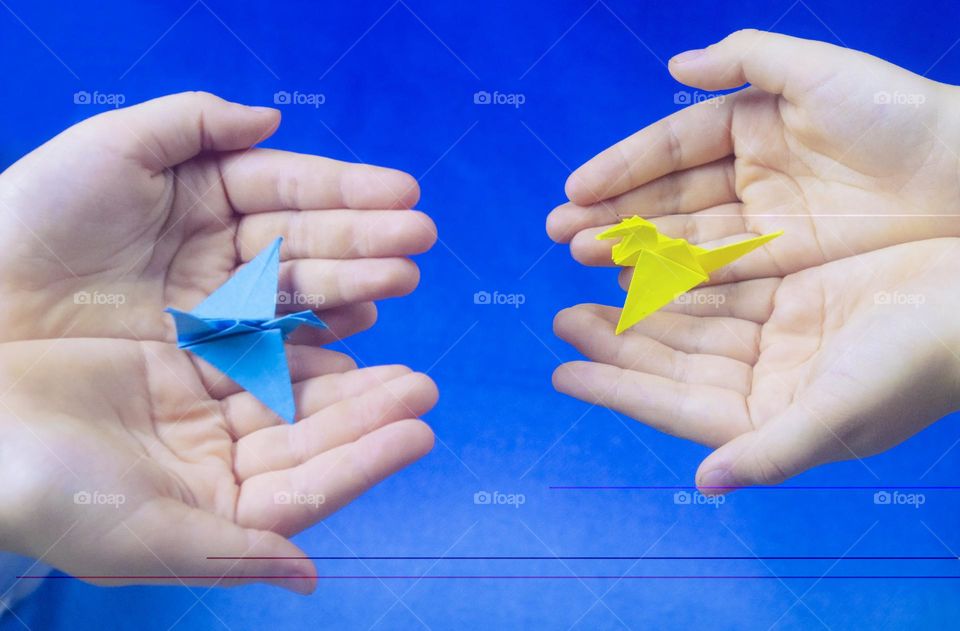 The child holds the origami cheering