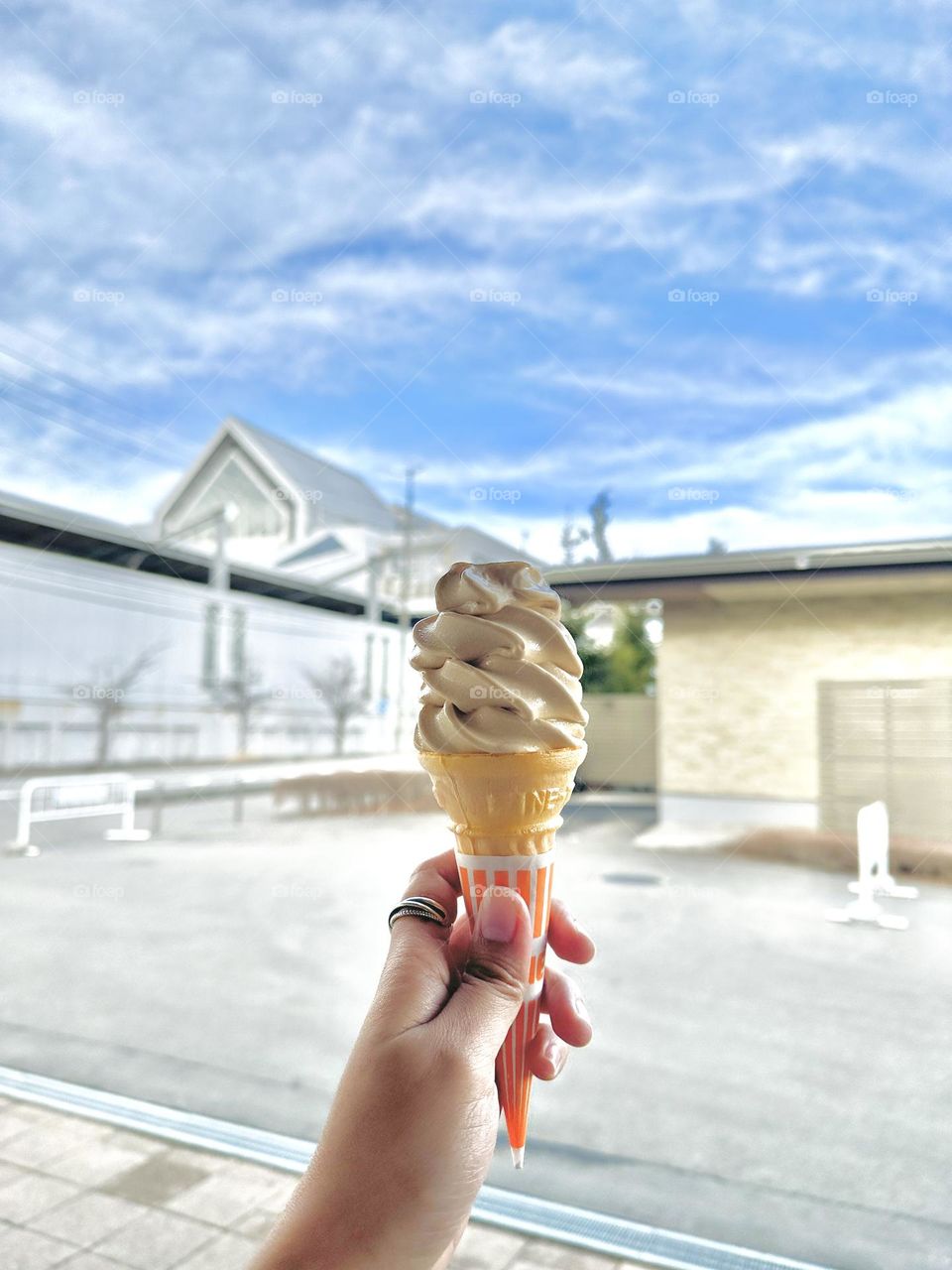 I find great pleasure in having ice cream under the blue sky.