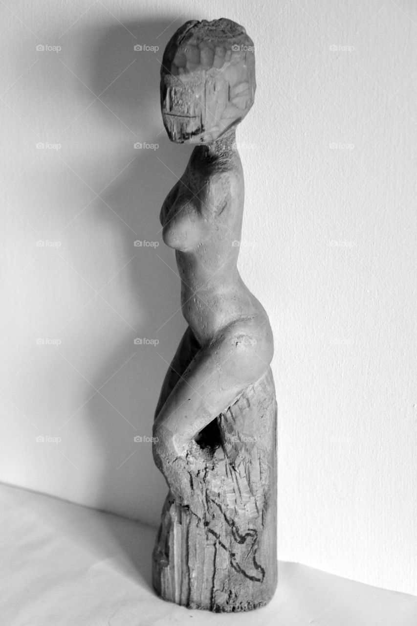 naked body of a woman, wood carving