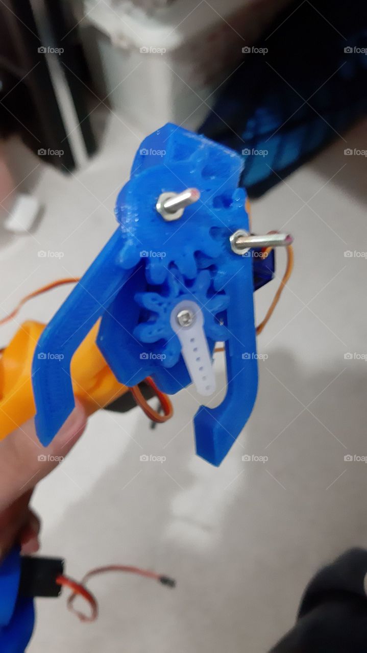 gears robotic arm gripper with blue coloured 3d printed printer filament PLA with nuts and bolts screws servo white orange coloured base
