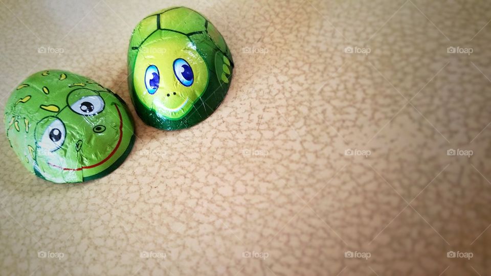 A pair of smiling lady bugs. These are actually chocolates wrapped up in decorative aluminum foil.