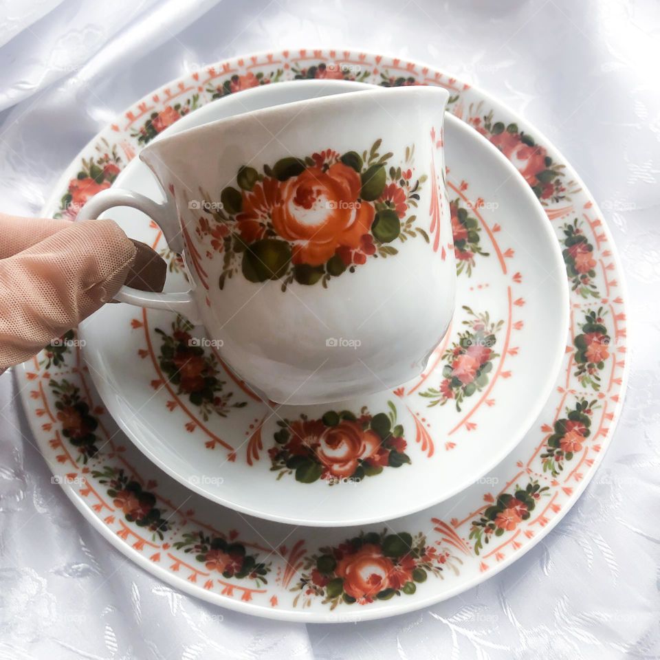 Old porcelain tea trio set with red floral ornaments