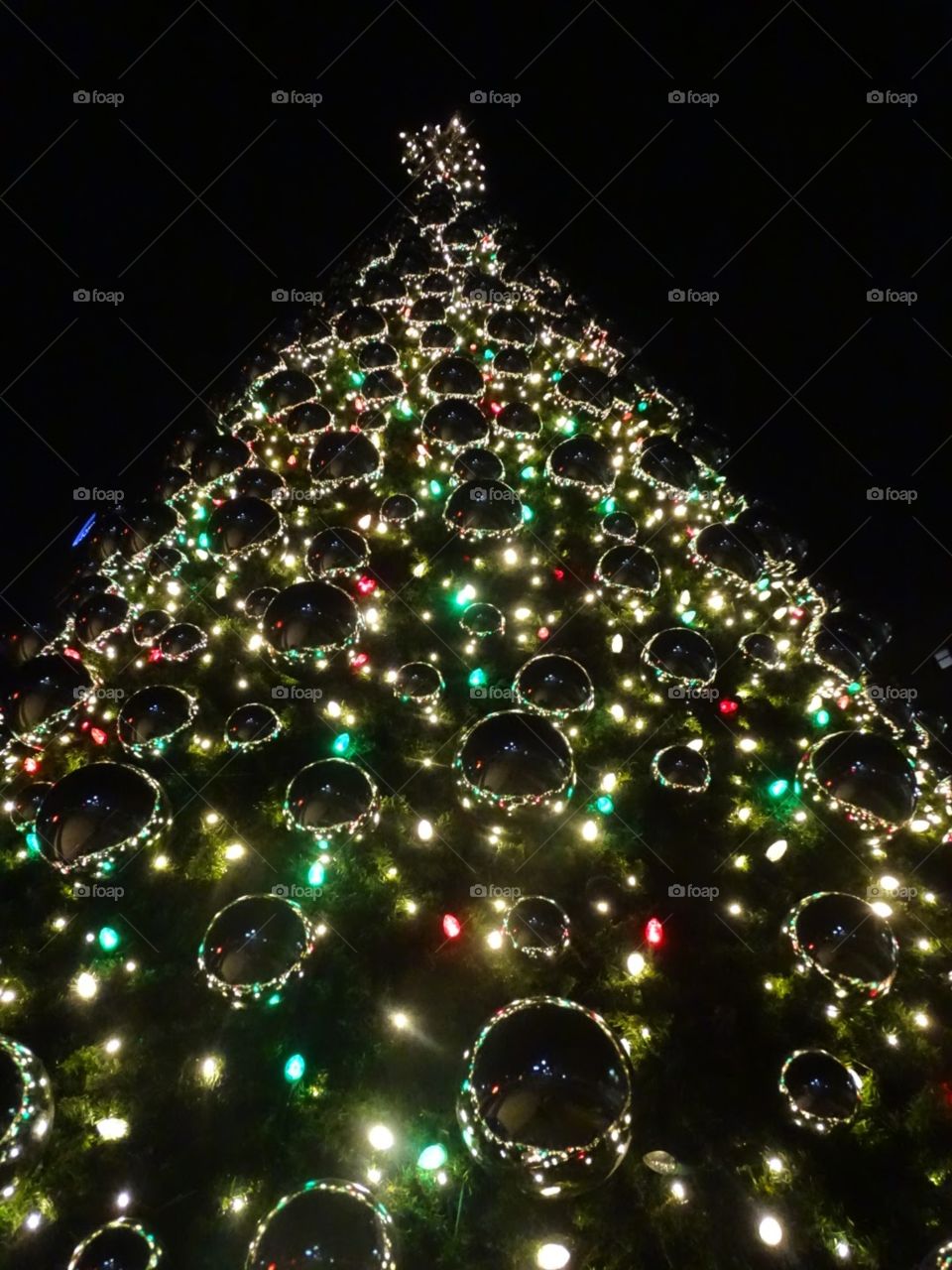 Looking up at an ornate Christmas tree.