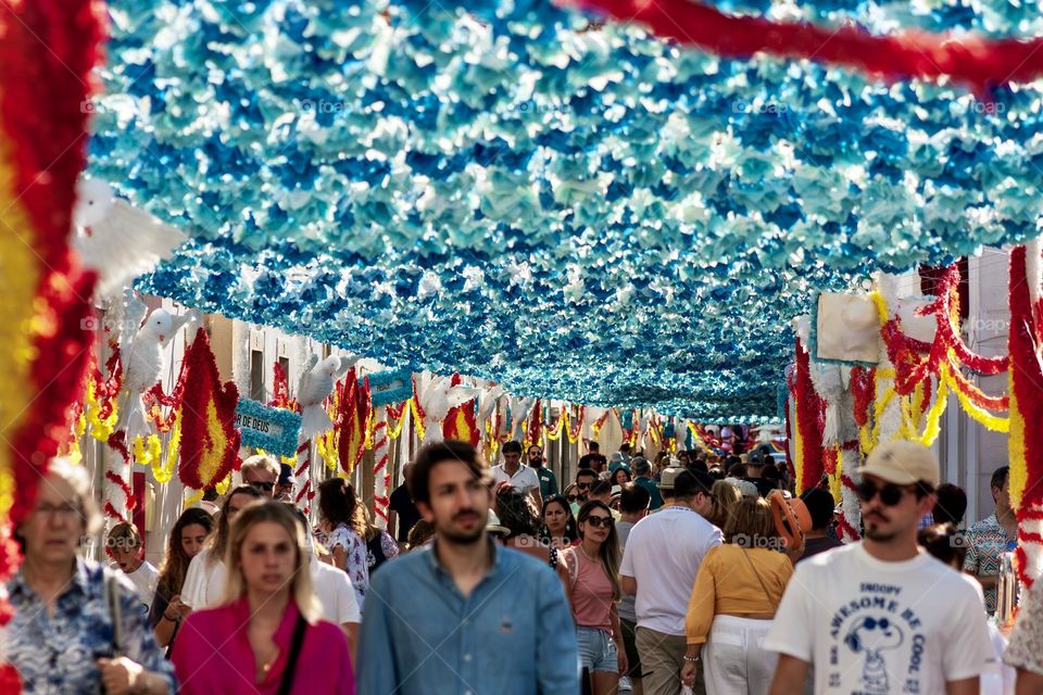 Crowds of people enjoy the colourful decorations in the city of Tomar, Portugal for the 2023 Festas Dos Tabuleiros 