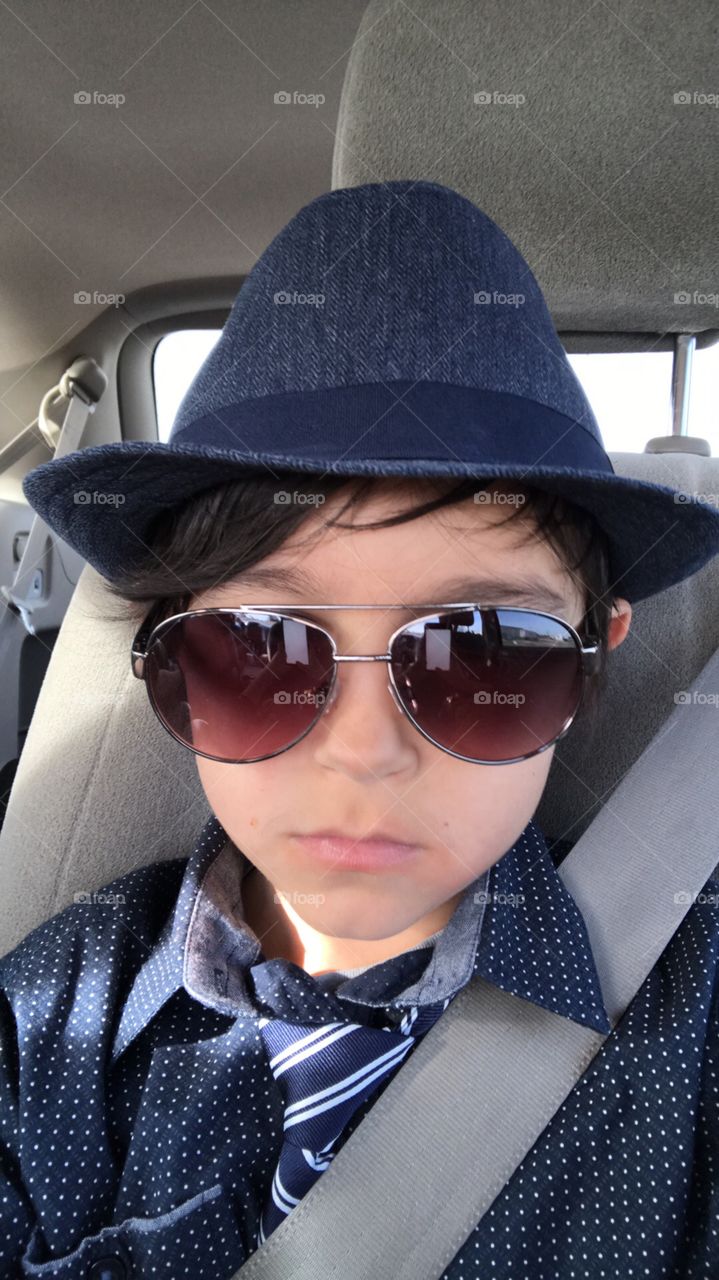 Little boy selfie in the car ready for church