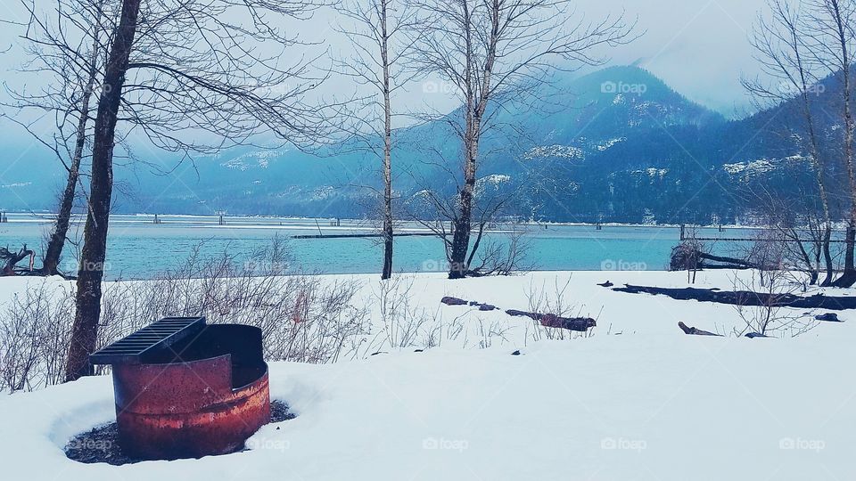 snow covered beach with mountains