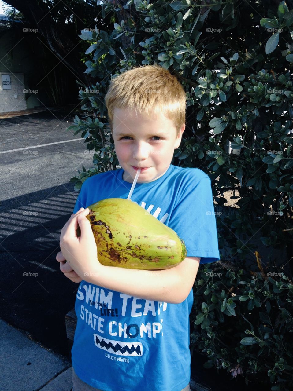 Darling photo of young boy drinking water out of coconut in tropical paradise!! 