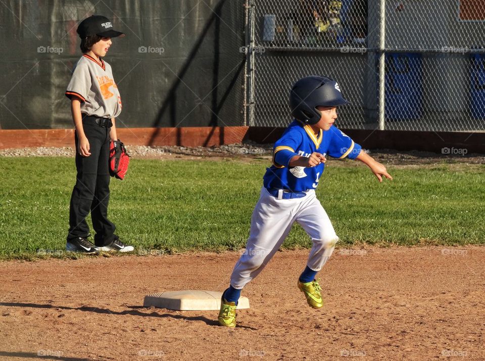 Little League Player Running The Bases. Running In Sports
