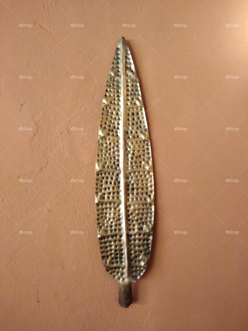 a brass leaf on the wall