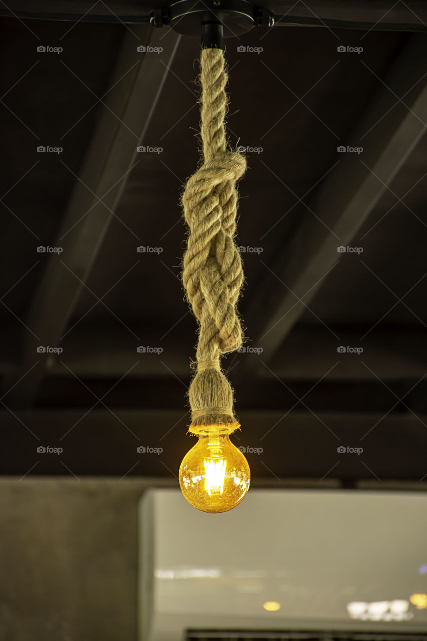 Yellow light bulb The sphere hanging with a rope.