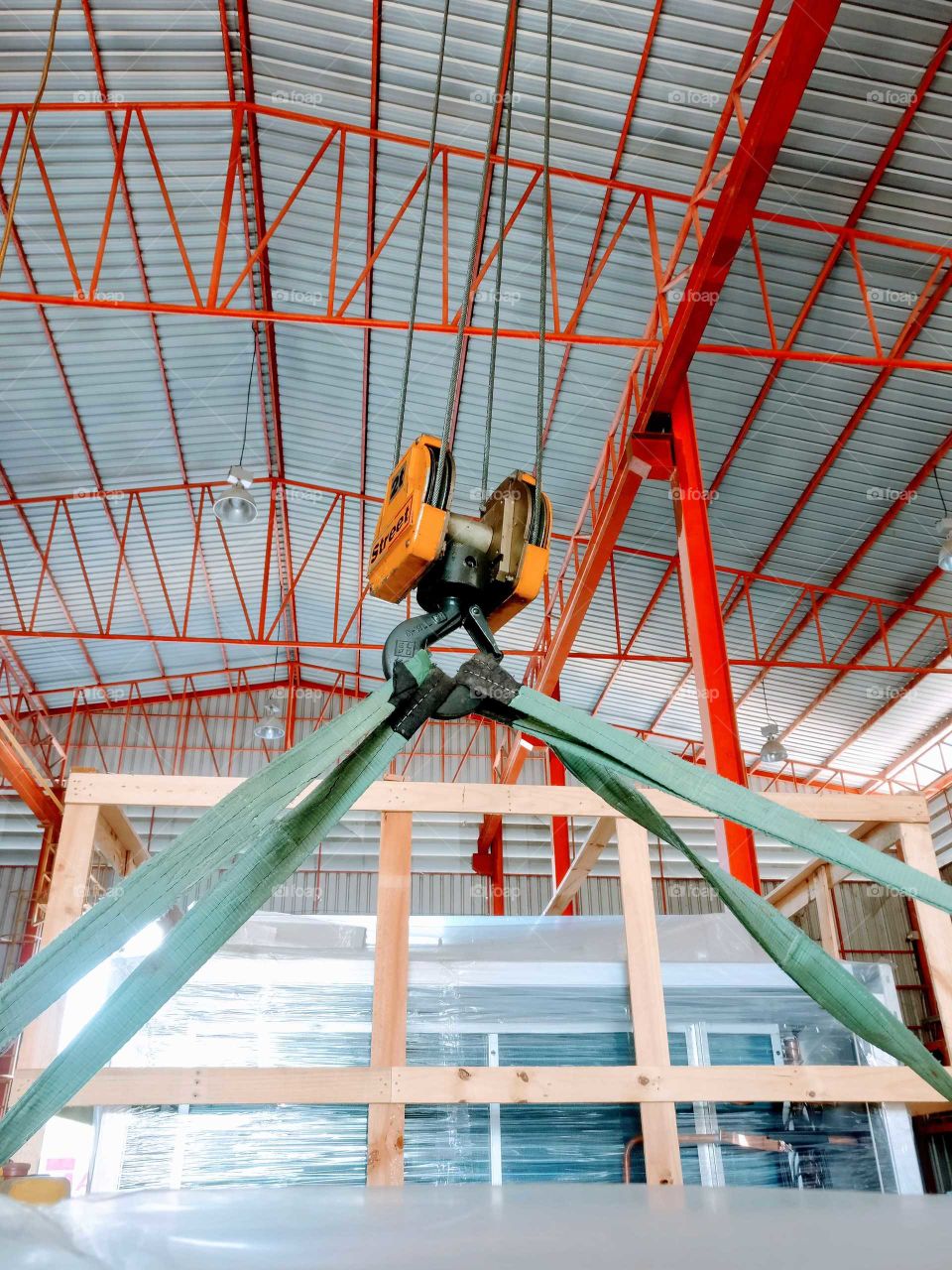 Lifting heavy equipment with overhead crane