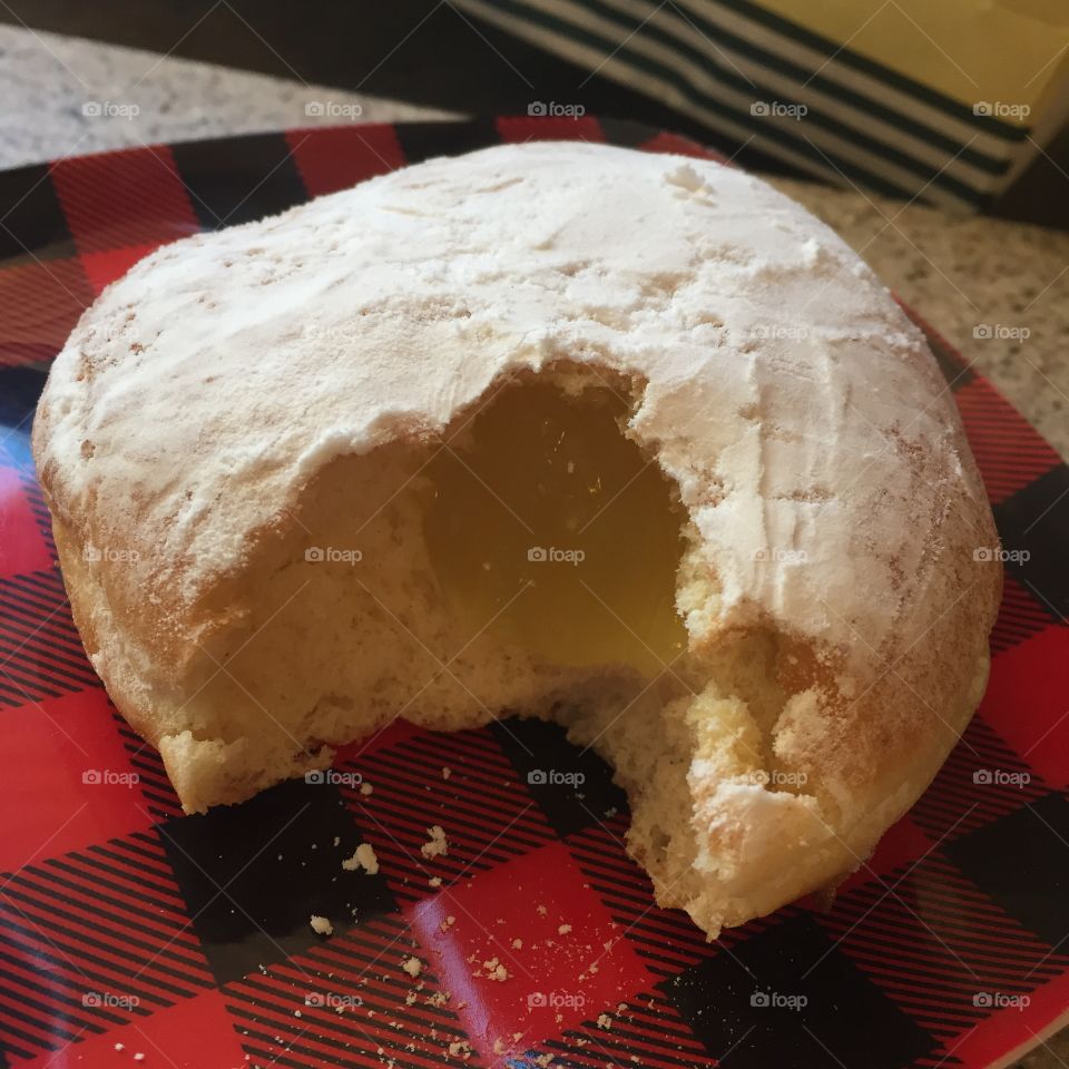 Lemon filled doughnut with bite