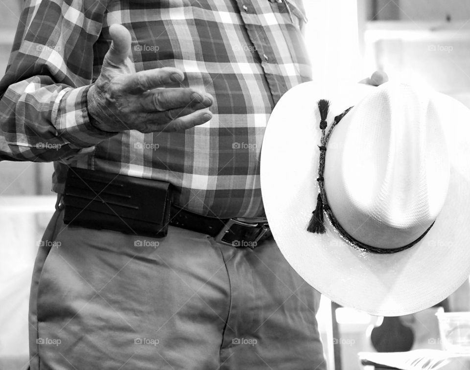 Close-up of cowboy holding hat