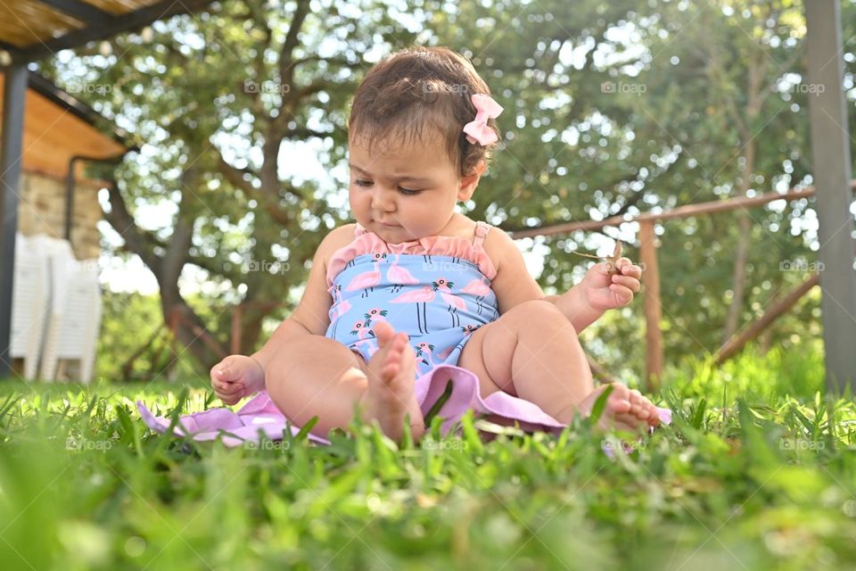 little girl playing on the lawn