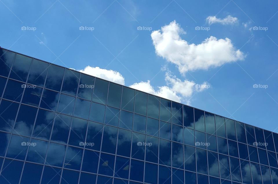 Clouds floating by reflecting on windows adds a simple beauty.