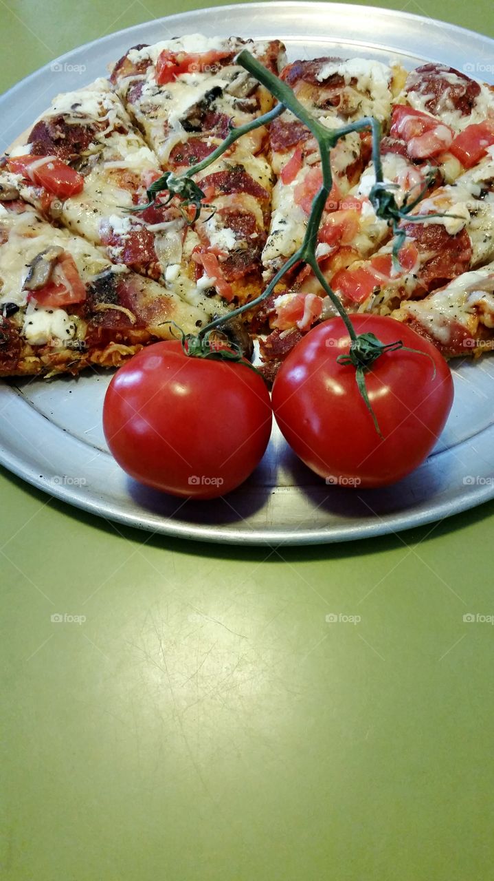 pair of vine ripened tomatoes and homemade pizza