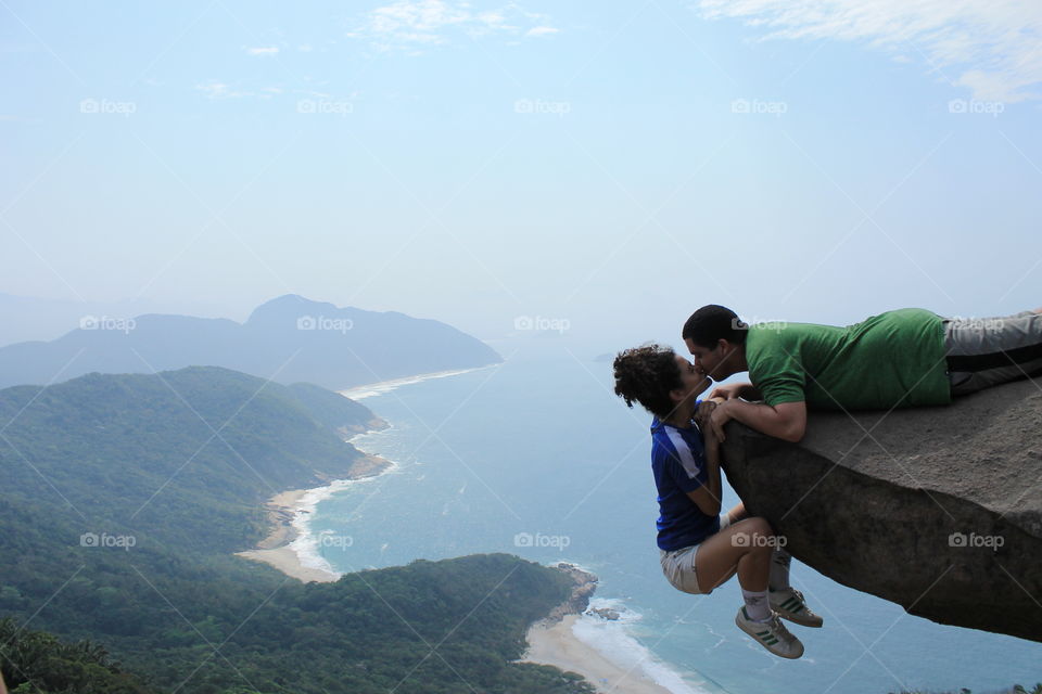 Risk Lovers. Couple kissing at a beautiful pointview in Rio de Janeiro. There's a little trick to do so.
