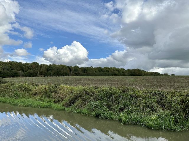 Beautiful weather for narrowboat cruise on Oxford canal late summer vacation in England lovely sky cool clouds horizon treeline water bank