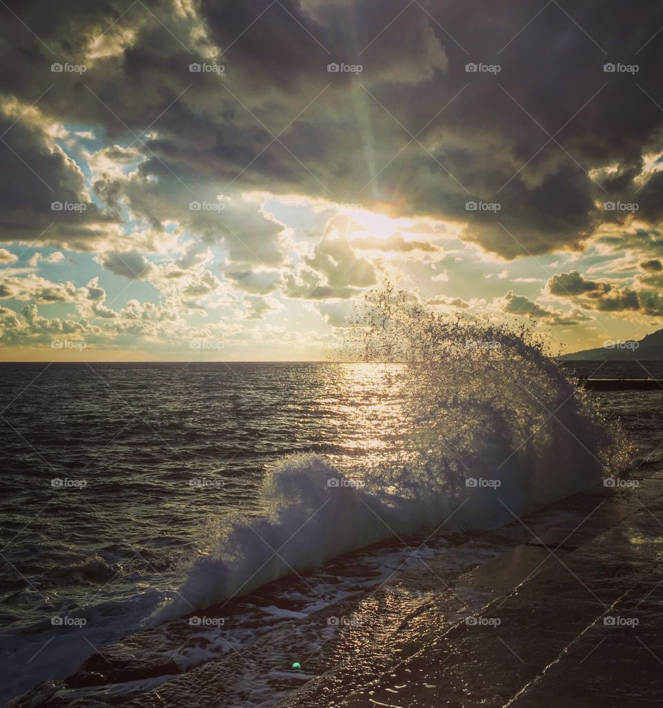 Waves and sunset above the sea