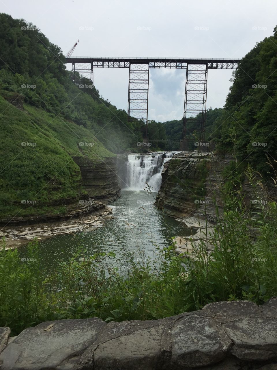 Waterfalls and gorge known as Letchworth Park in New York with a working train trestle from the 1800's. 