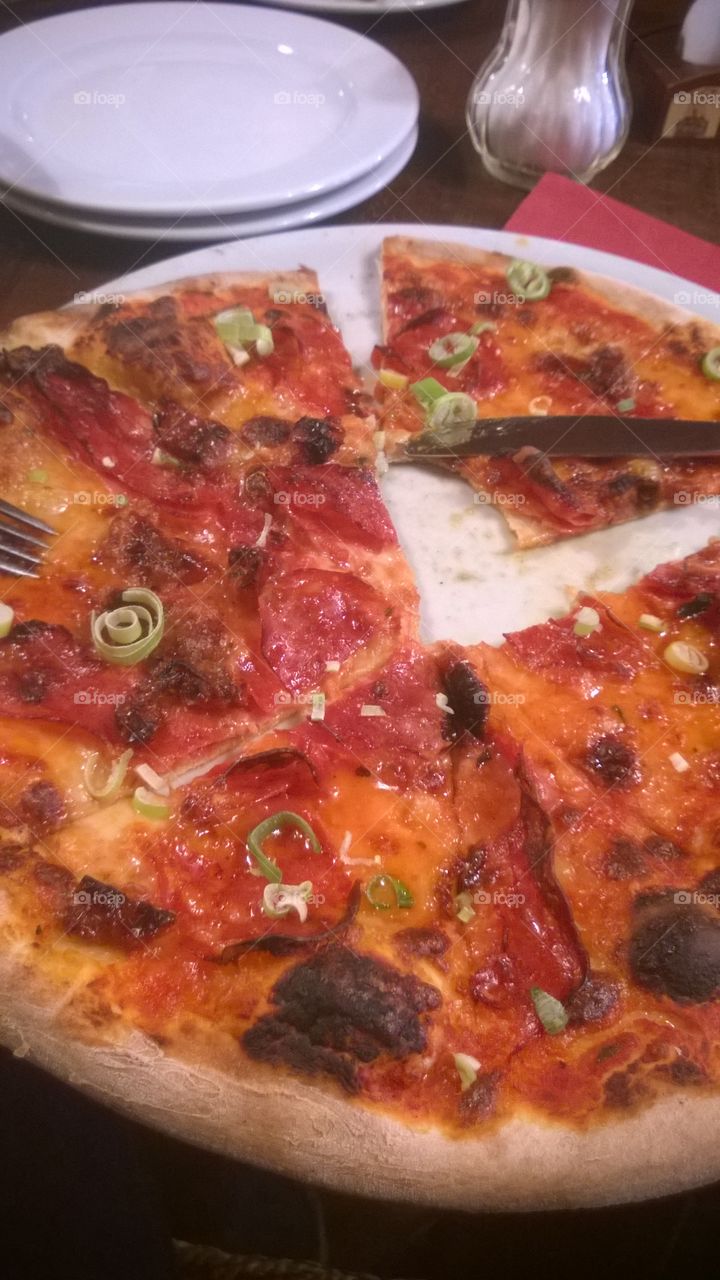 Pizza with green onion in Prague