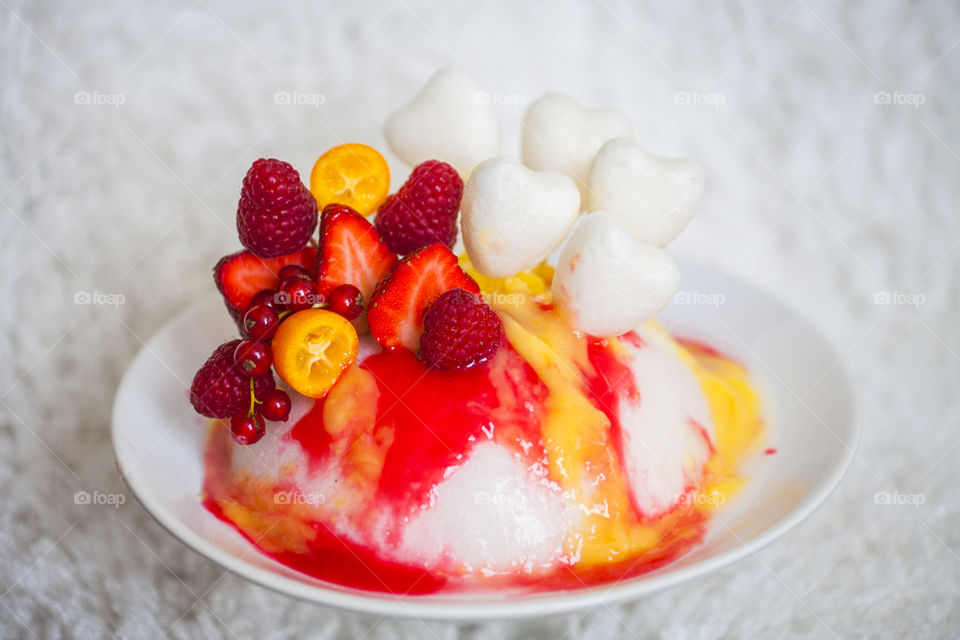 coconut jelly with berries juicy colorful yellow red pink strawberry raspberry red currant kumquat coconut hearts white background 