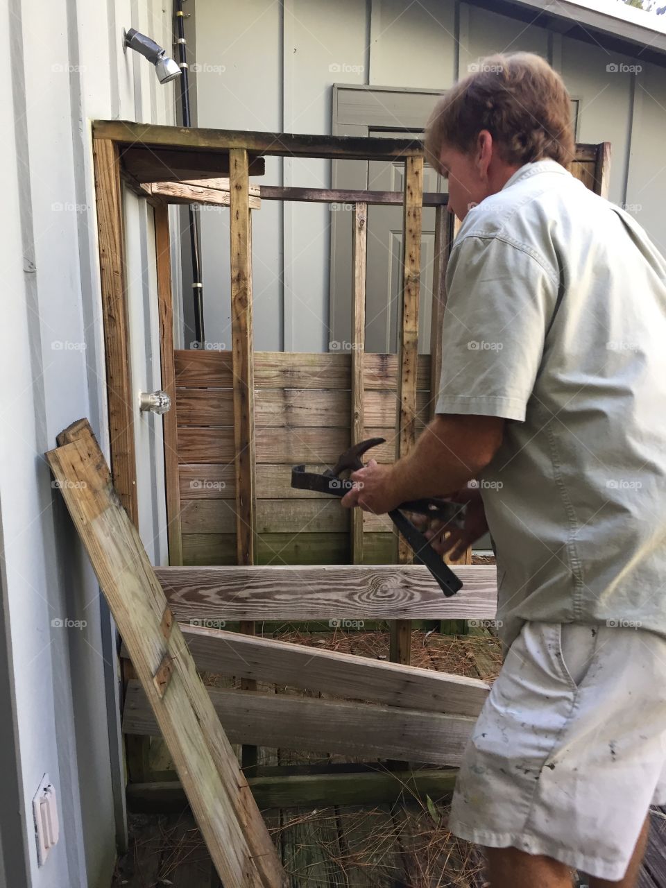 Man building a wall with a hammer
