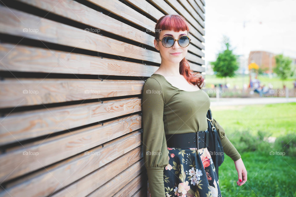 beautiful pin up young woman. beautiful young woman with sunglasses in the city smiling