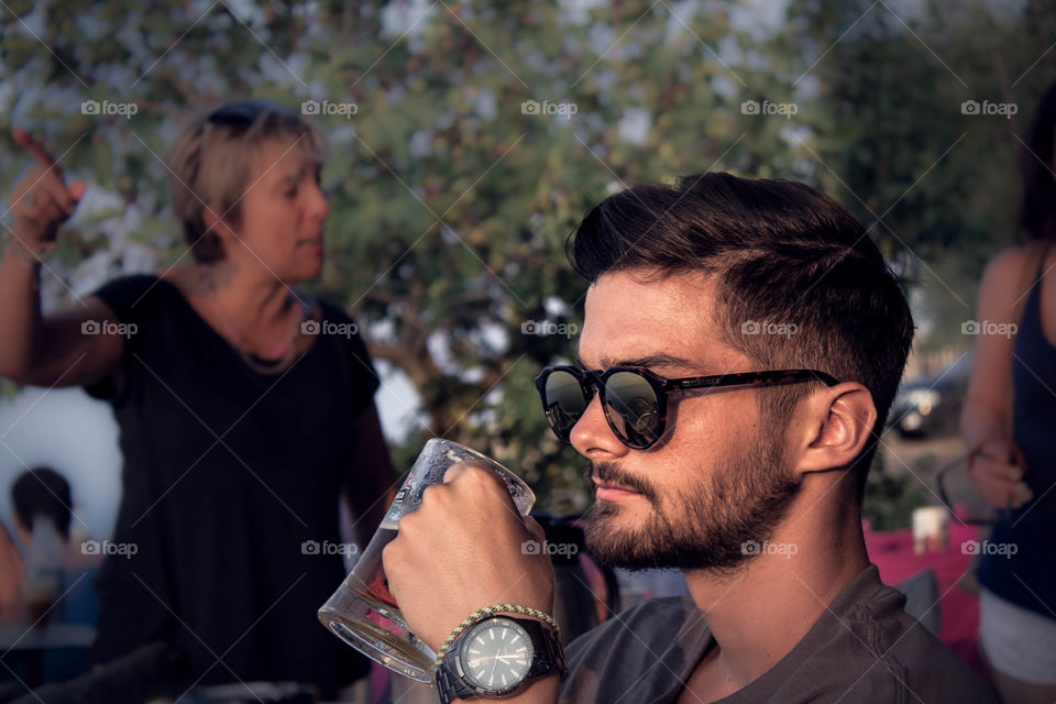 man drinking beer from a