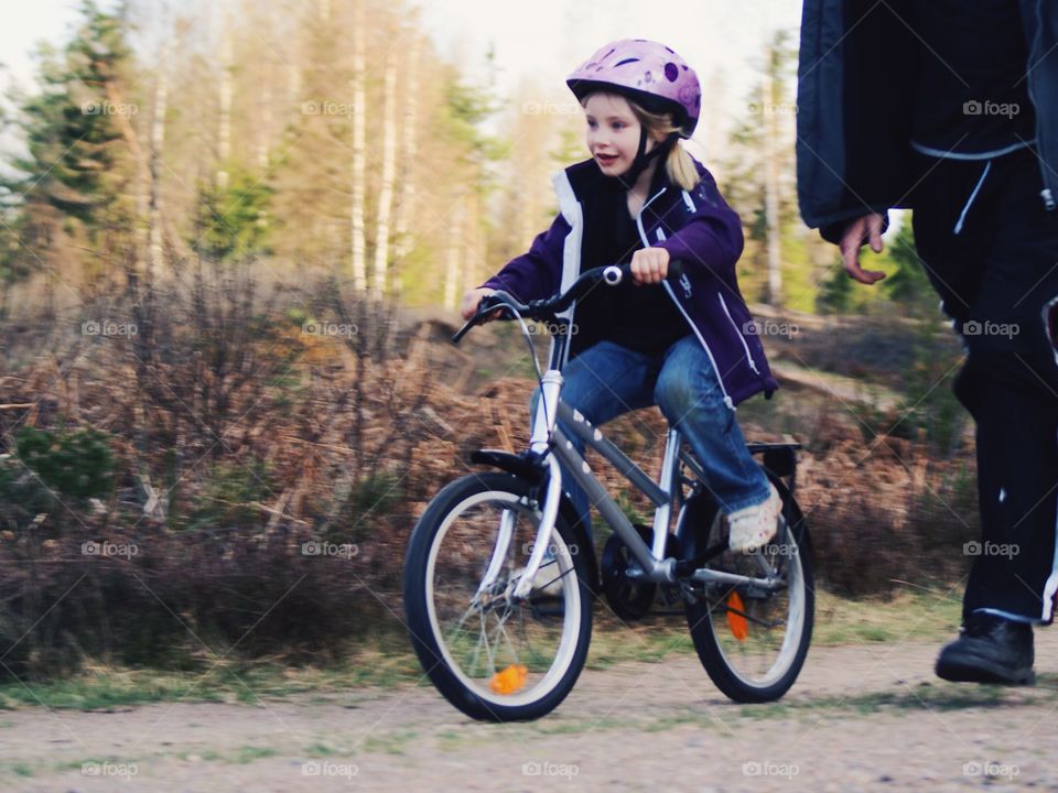 Joy. Girl bicycling on her own for the first time