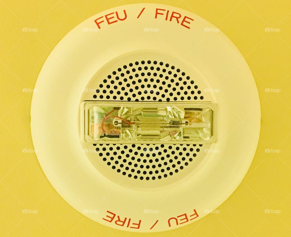 Old school fire alarm and sprinkler system  in retro yellow colours.