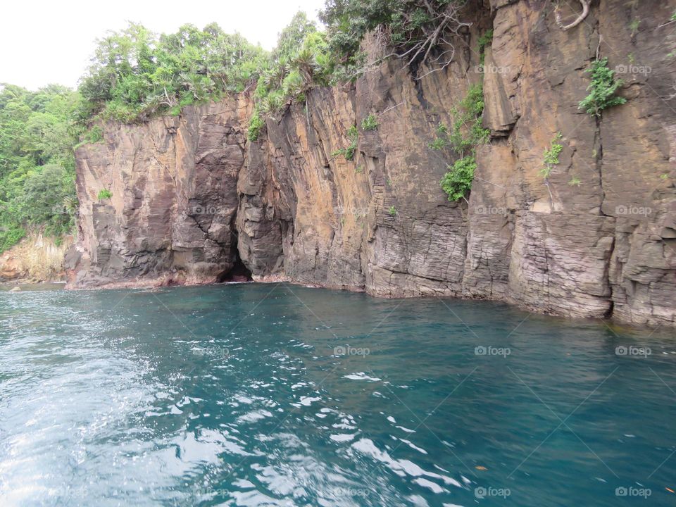 The view from the coastline is rugged with unique rock formations.