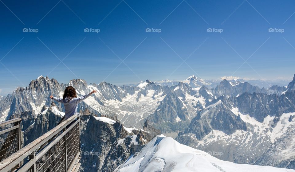 Woman stretching her arm on lookout tower