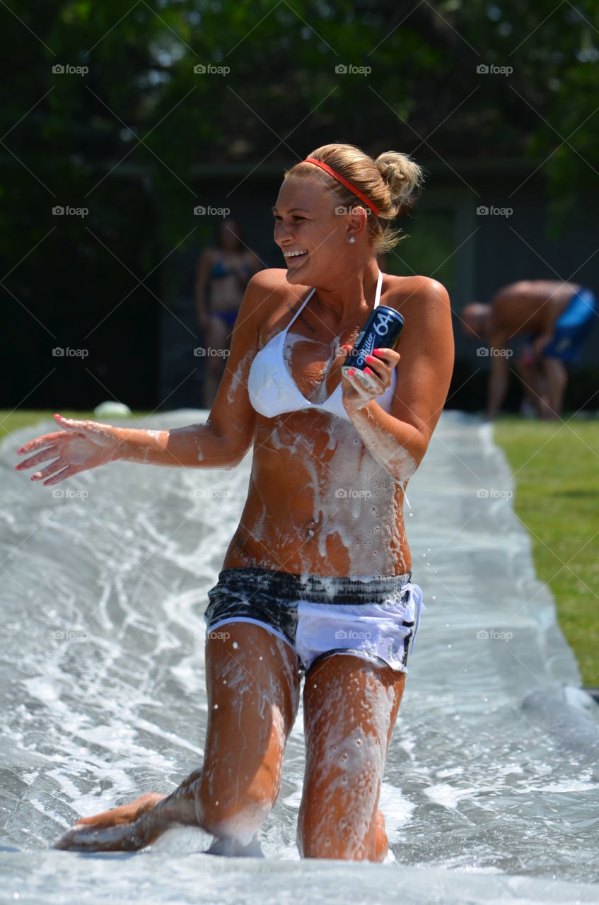Woman in soap stud holding aluminum tin