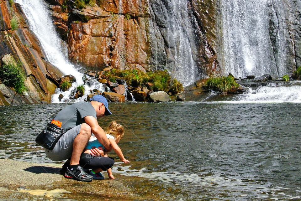 dad with daughter at the waterfall