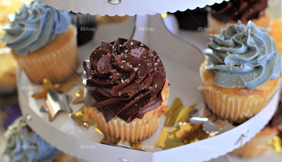 Close up of a cupcake with chocolate frosting and sugar crystals 