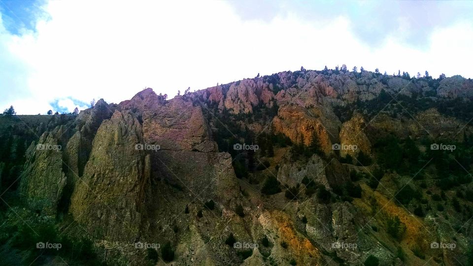 Rocky Forest. A beautiful tree dotted mountain seen from the side of the highway. The ability of these trees to survive in the rugged conditions are a true testament to the willpower of Montanans.