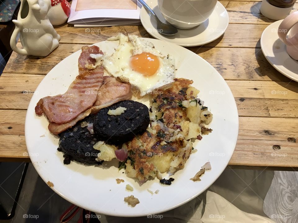 English breakfast ... fried egg, bacon rashers black pudding and fried potato 