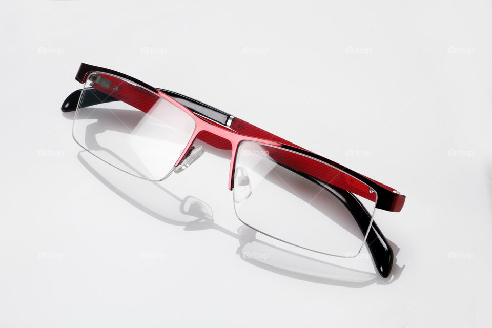 Eye glasses on white reflective background