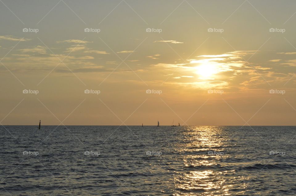 sailboats at sunset in the sea