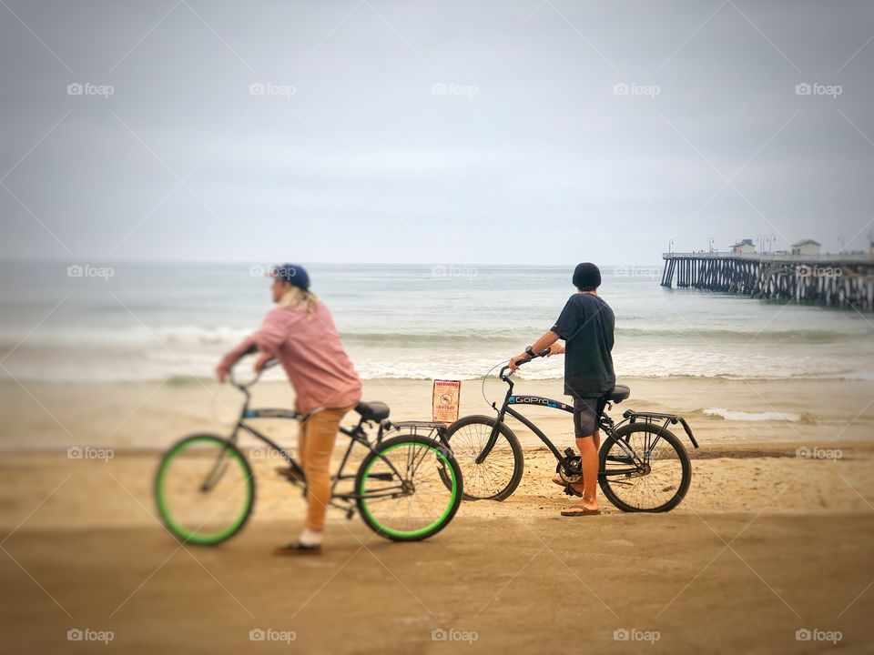 Staying in Good Shape! Two Men on Bicycles On The Beach!