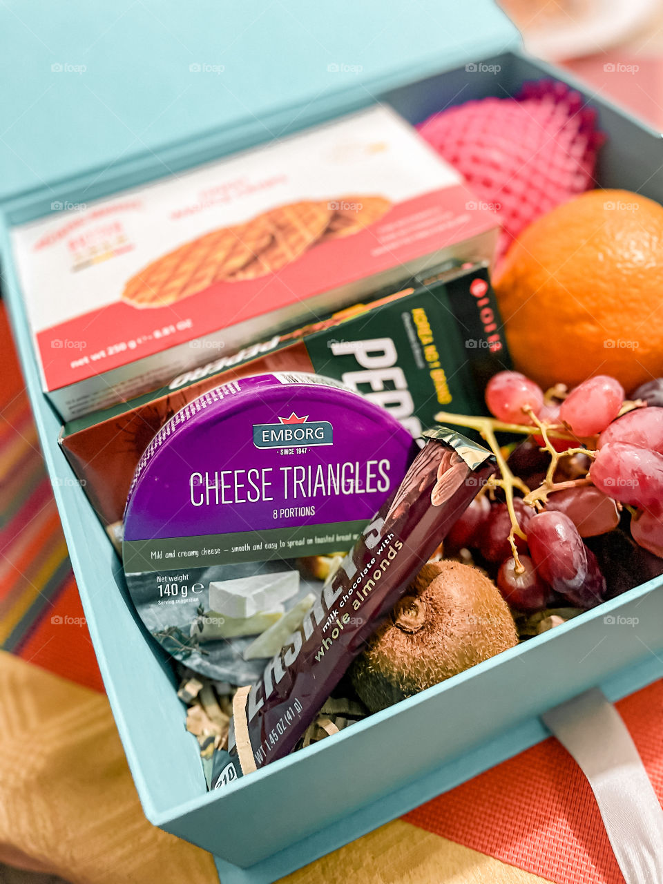 Graze box filled with fruits, cheese, chocolates and crackers. 