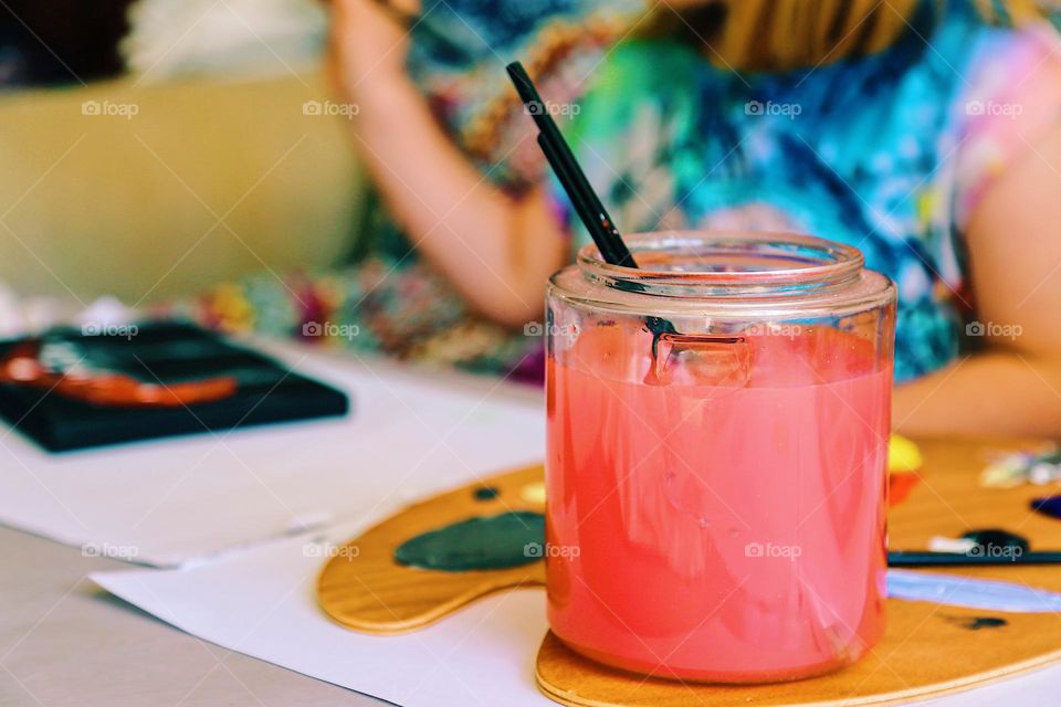 Paint brushes in water that has turned into red