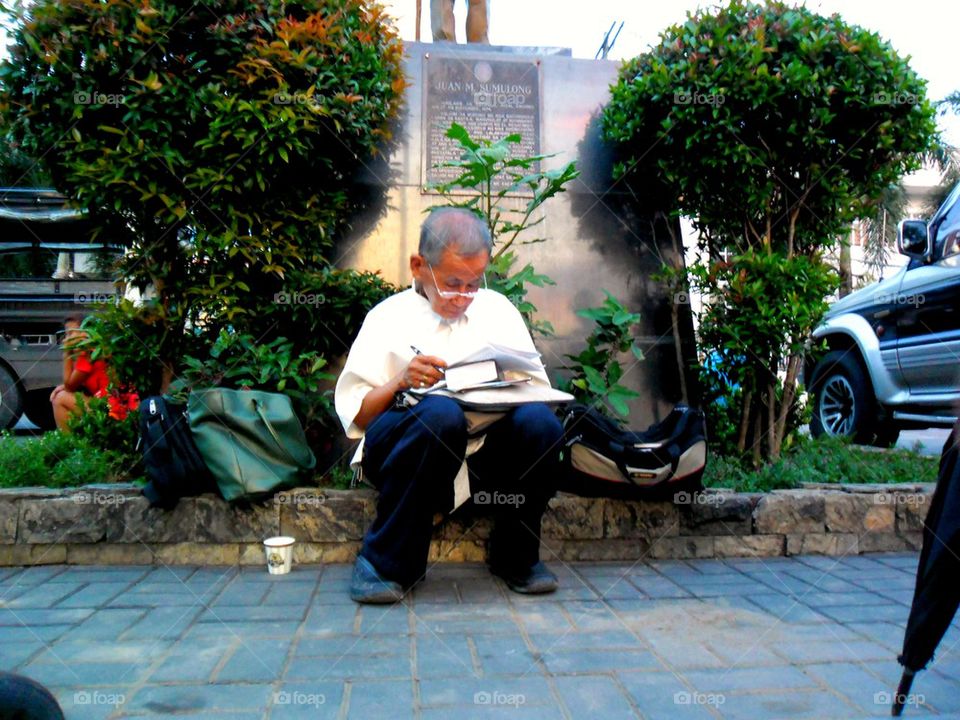 old man sitting at a park