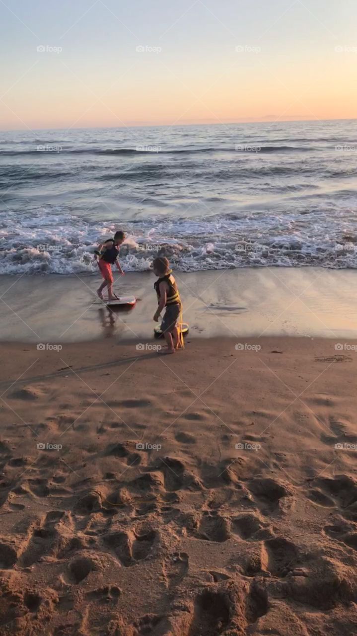 Children surfing in the Pacific Ocean 