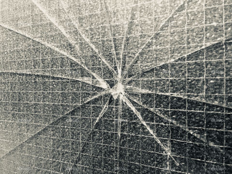 Cracked glass window panel of door on Snowsfields, Southwark, nr Guy’s  Hospital, observed in Winter.